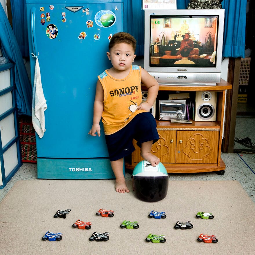 Boy playing with a ball and toy car