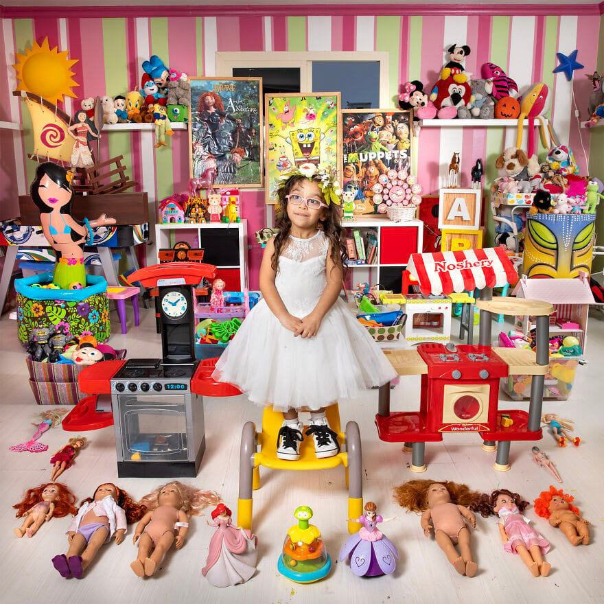 A girl with a doll and toys