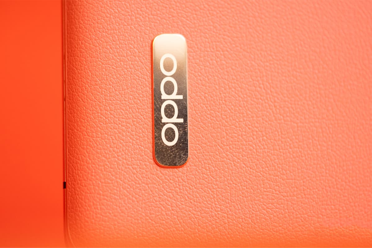 Oppo logo / Oppo / Oppo on the back of an orange phone
